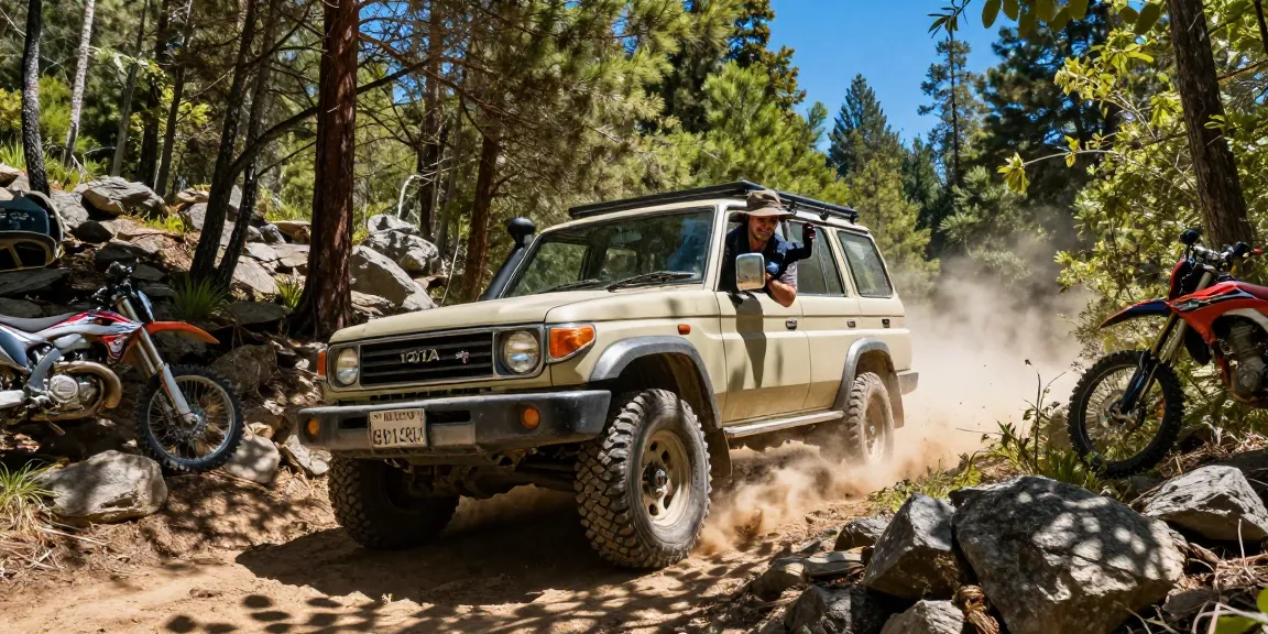 David Vepraskas Atlanta enjoying an off-roading adventure in his Toyota Land Cruiser, driving through a scenic forest trail.